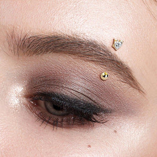 Gold Eyebrow Piercing